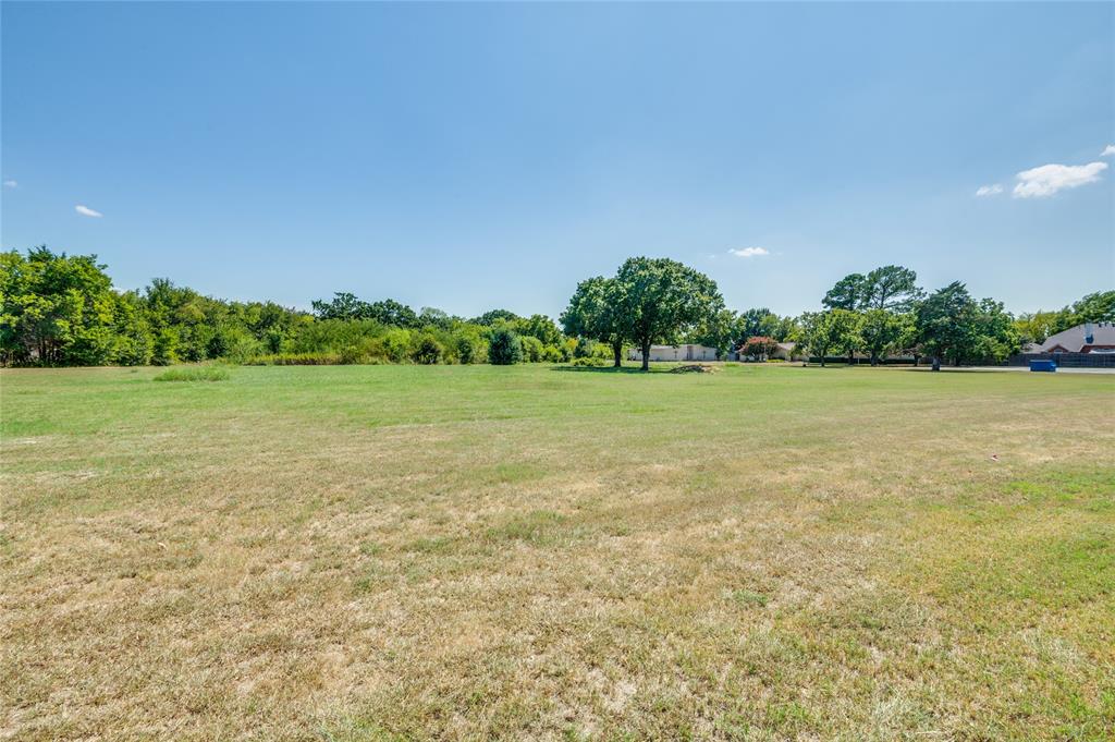 2120 West Sublett Road Arlington, TX 76001 - Photo 11 of 12 a view of a green yard and a building