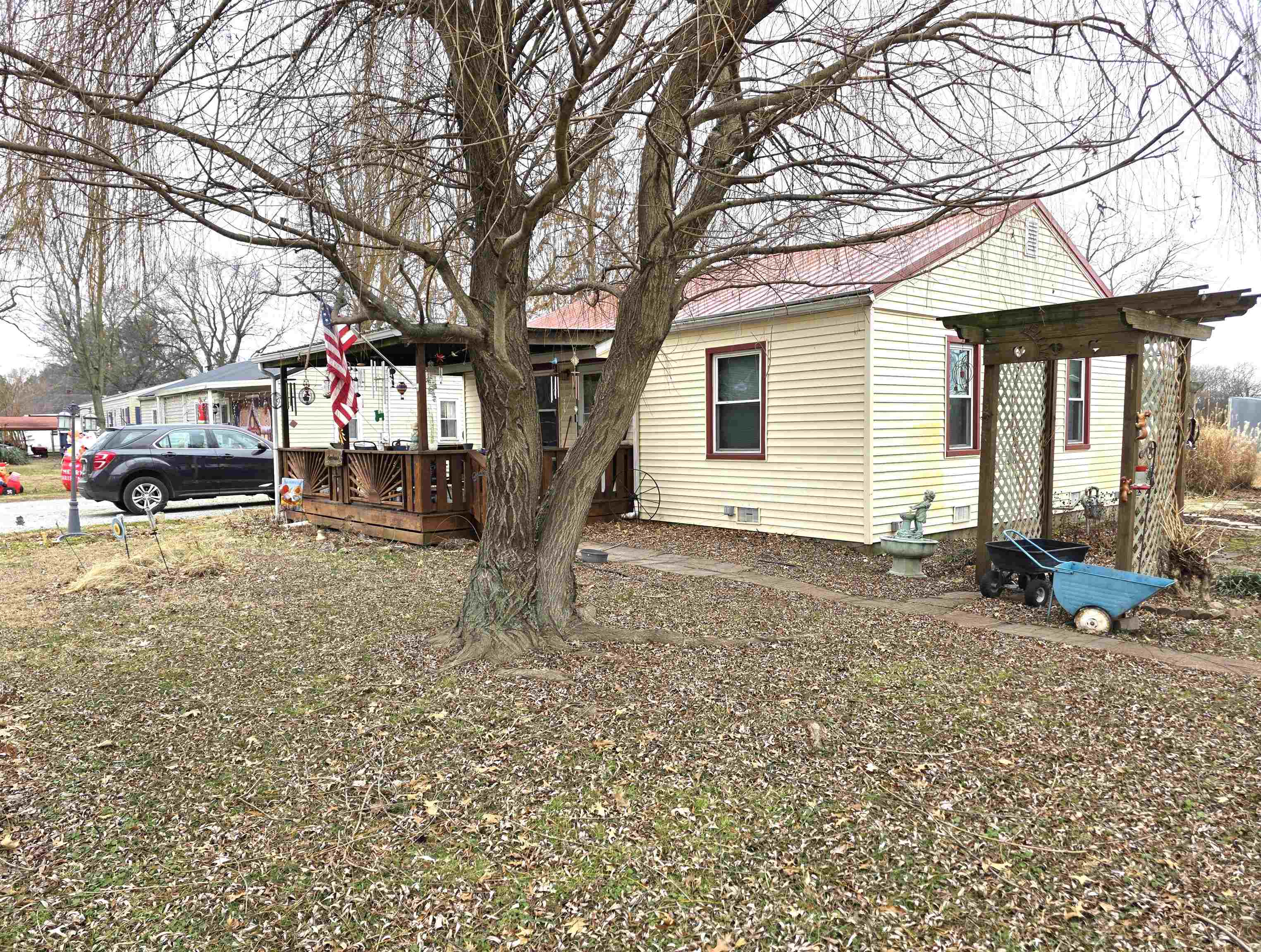 a view of a house with a yard covered in snow
