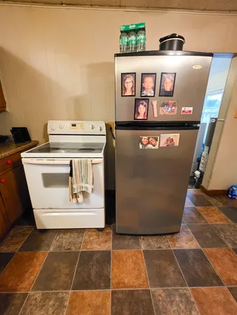 a view of a storage and utility room with a refrigerator