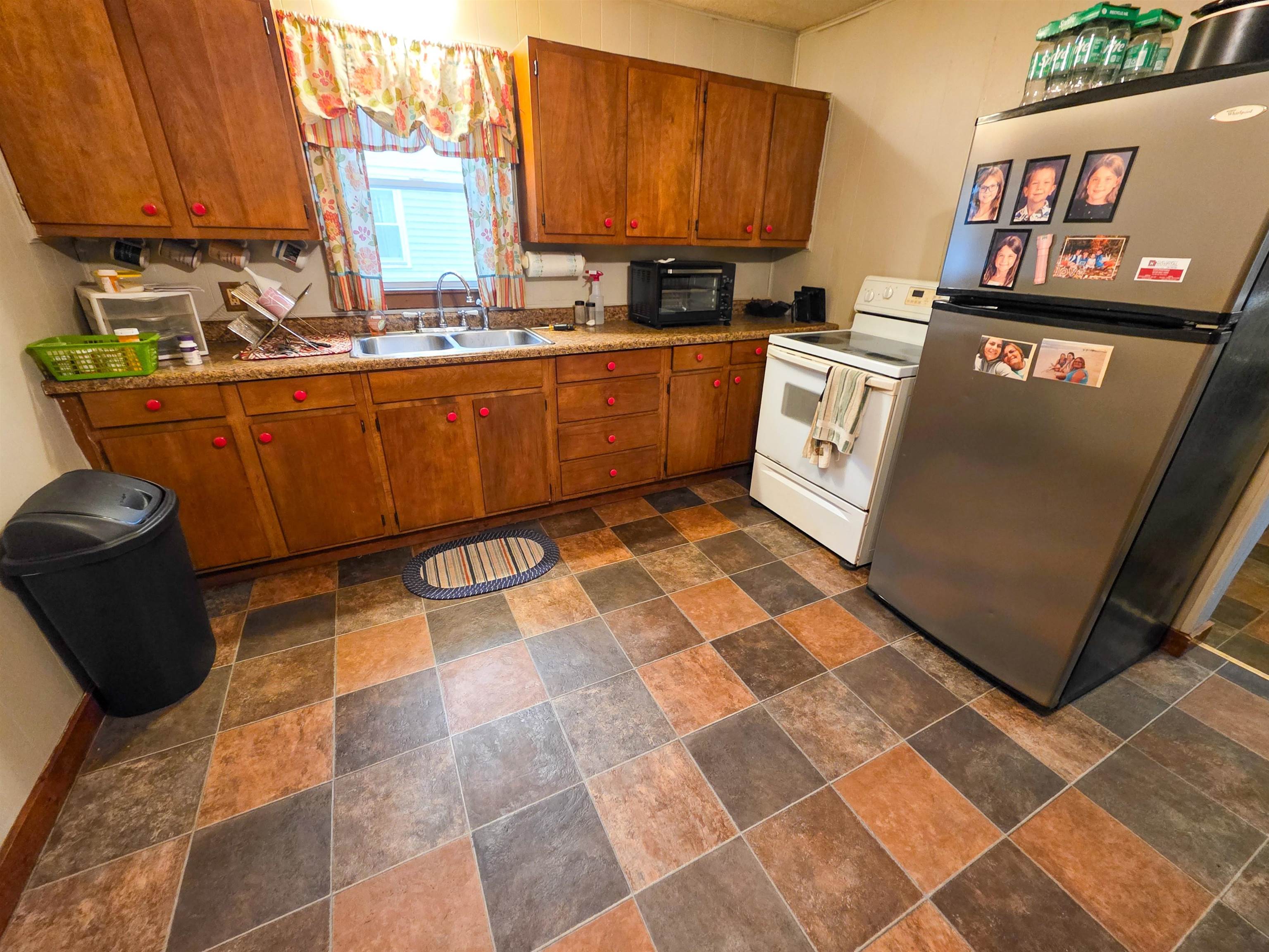 105 Watkins Street Cisne, IL 62823 - Photo 13 of 30 a kitchen with a sink a stove and a microwave