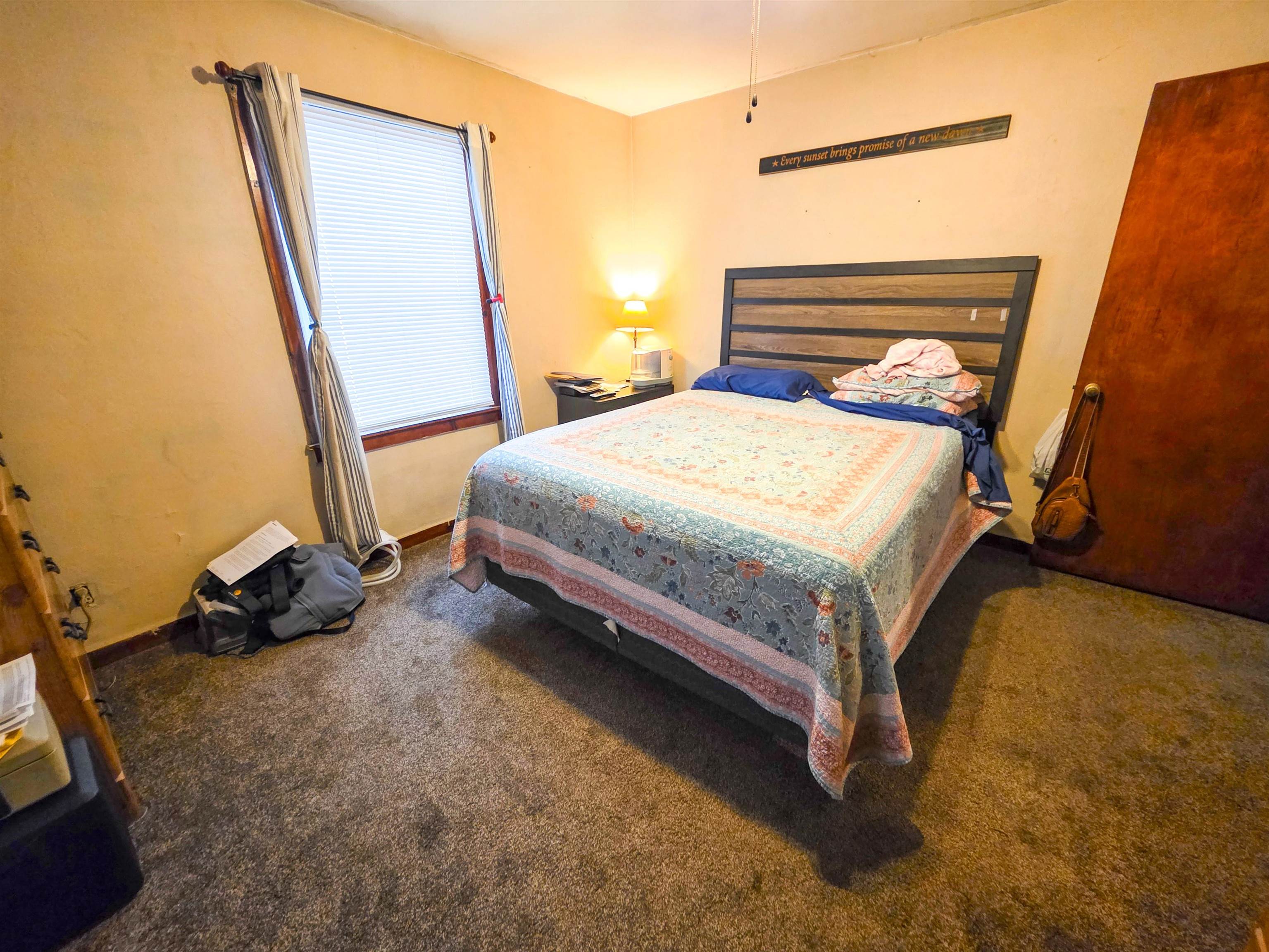 105 Watkins Street Cisne, IL 62823 - Photo 18 of 30 a bed sitting in a room next to a window