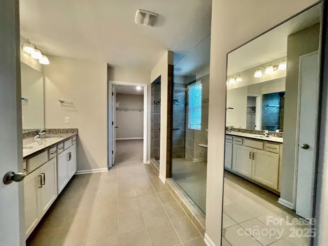 a bathroom with a double vanity sink and mirror