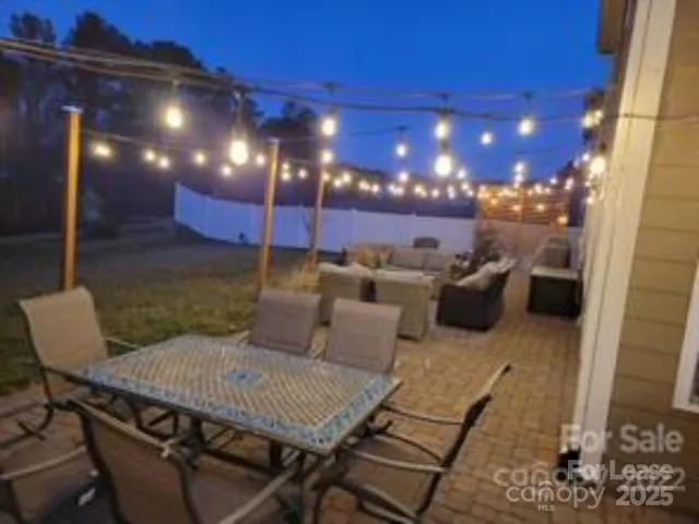 a view of a patio with a table and chairs