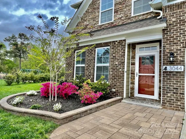 a view of a house with a flower garden