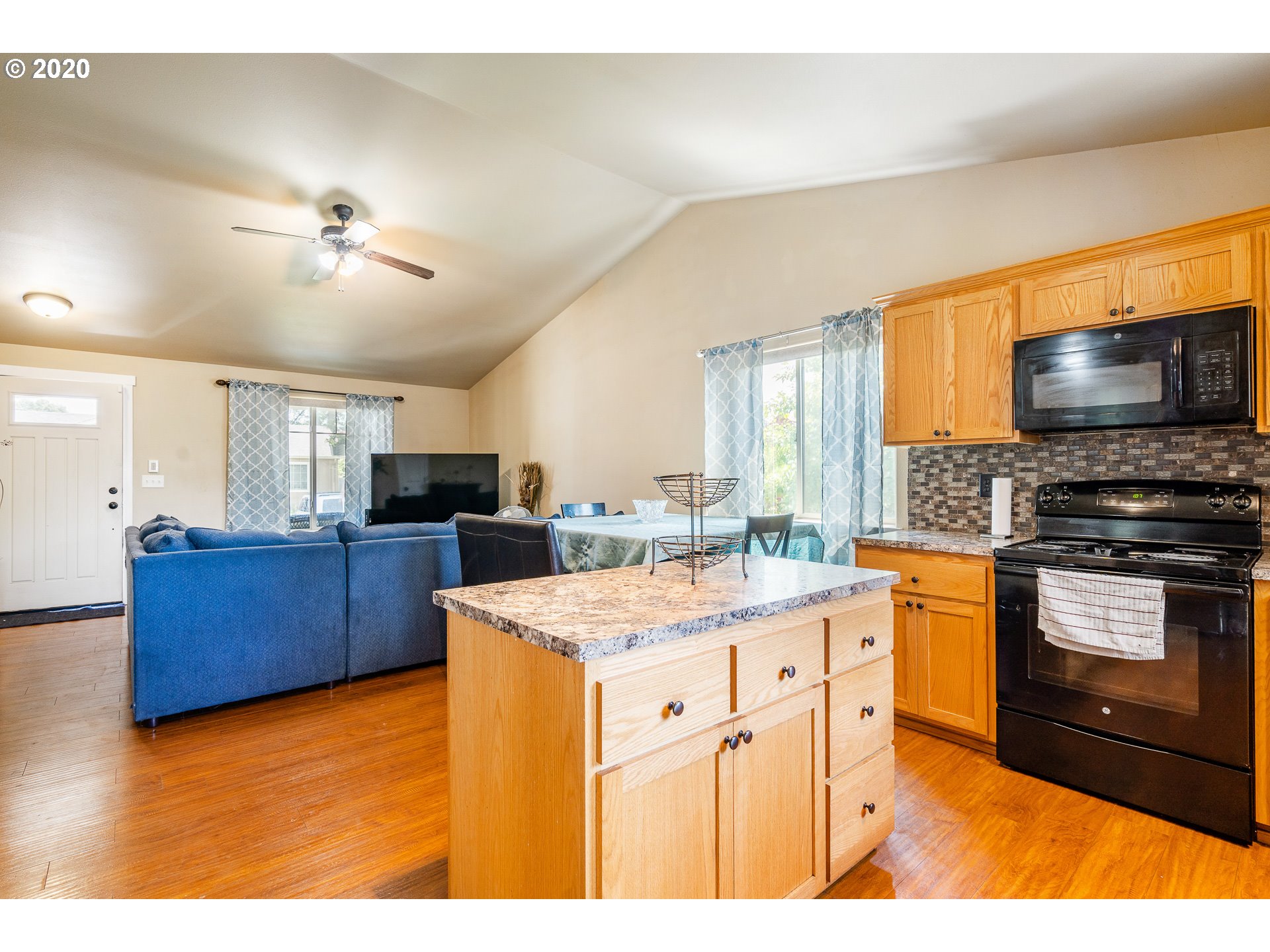 5181 B Street Springfield, OR 97478 - Photo 11 of 27 a kitchen with stainless steel appliances kitchen island granite countertop a stove and a sink