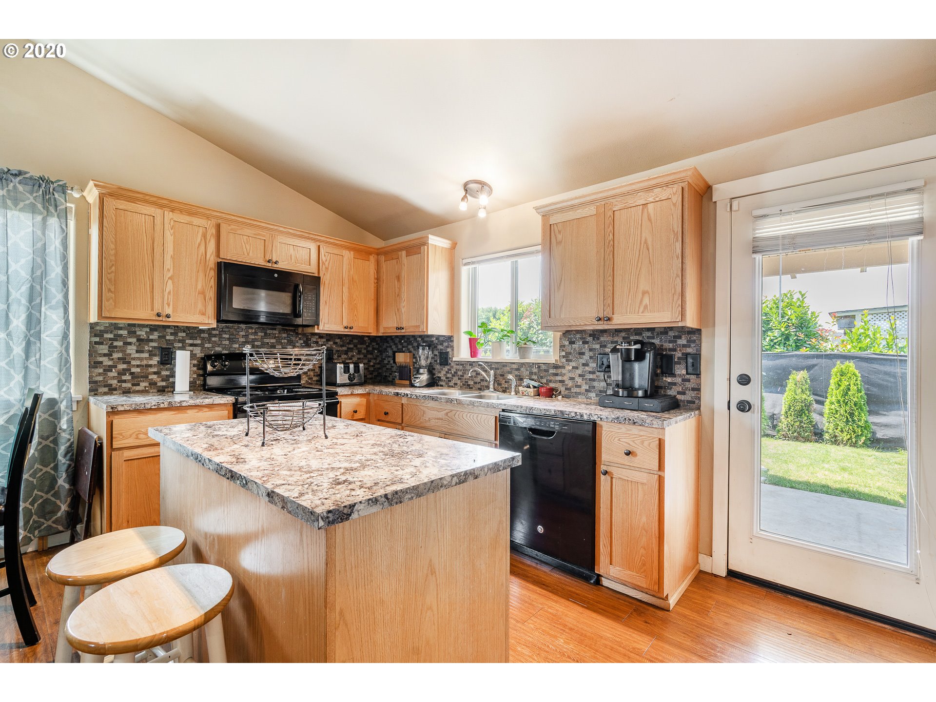 5181 B Street Springfield, OR 97478 - Photo 10 of 27 a kitchen with stainless steel appliances granite countertop a stove top oven a sink dishwasher and a refrigerator with wooden floor
