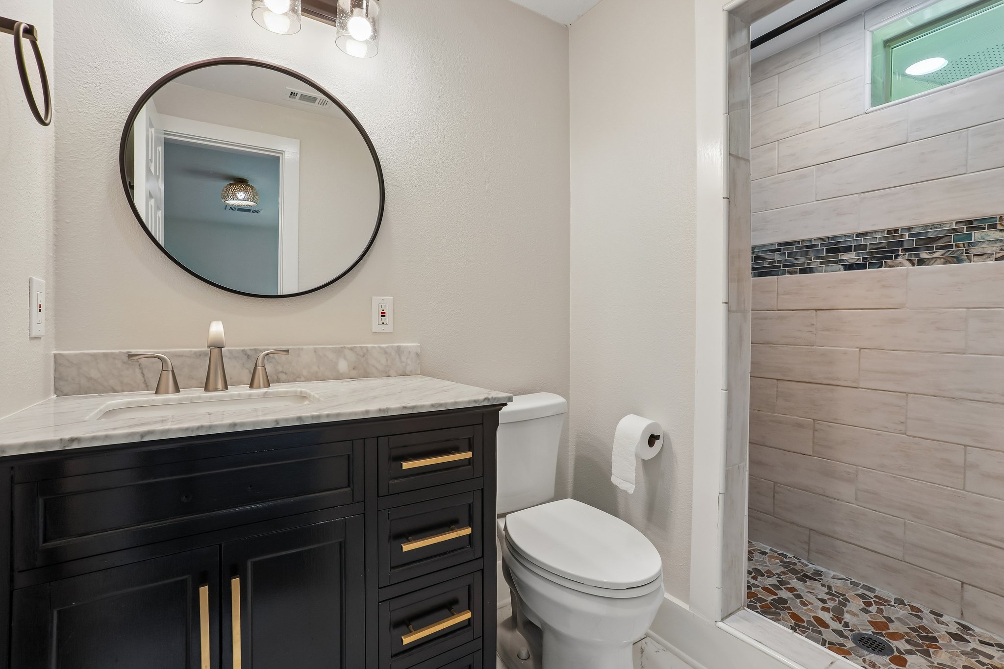 2089 Farm To Market Road 1704 Elgin, TX 78621 - Photo 21 of 31 A well-appointed bathroom features a dark wood vanity with a marble countertop and a mosaic-tiled shower.
