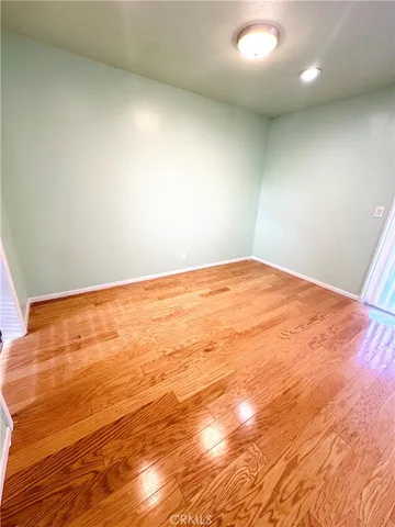 an empty room with wooden floor