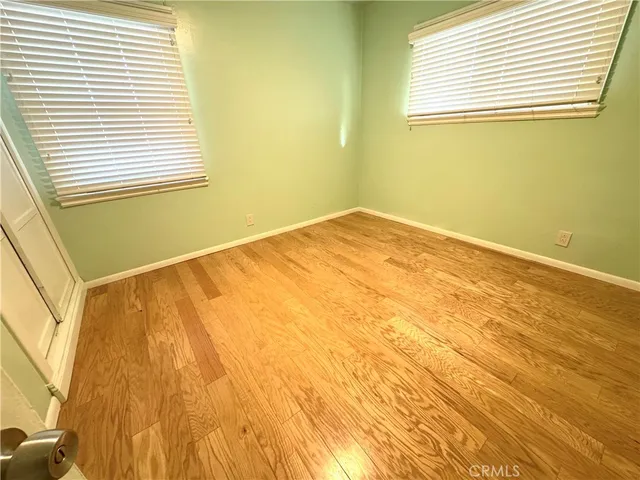 a view of a room with a wooden floor and a window