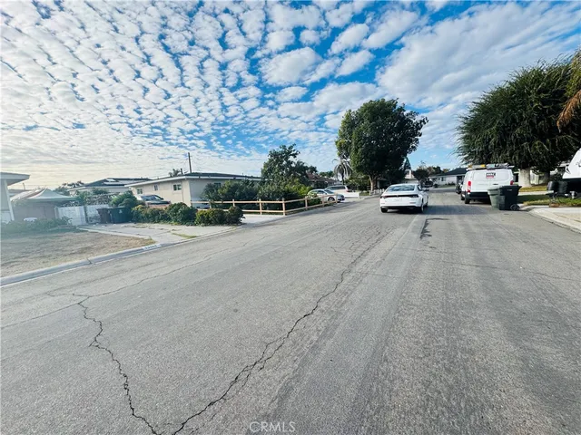 a view of street with parked cars