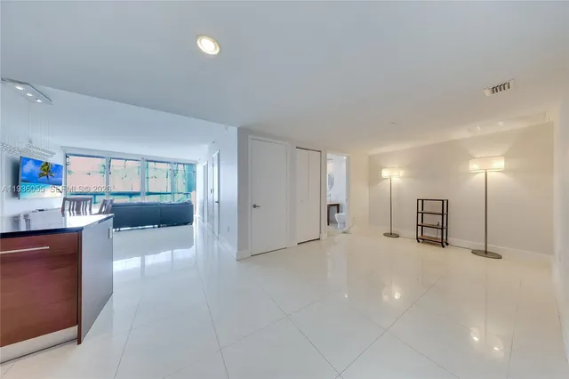 a view of a room with furniture and a kitchen
