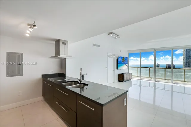 a kitchen with a sink a counter top space and appliances