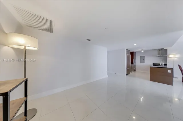 a view of a kitchen with a sink and a refrigerator