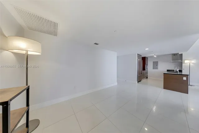 a view of a kitchen with a sink and a refrigerator