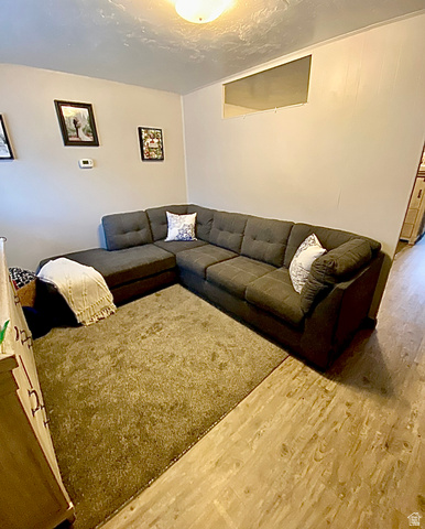 640 East 600 North Logan, UT 84321 - Photo 3 of 20 Living room featuring wood finished floors and a textured ceiling