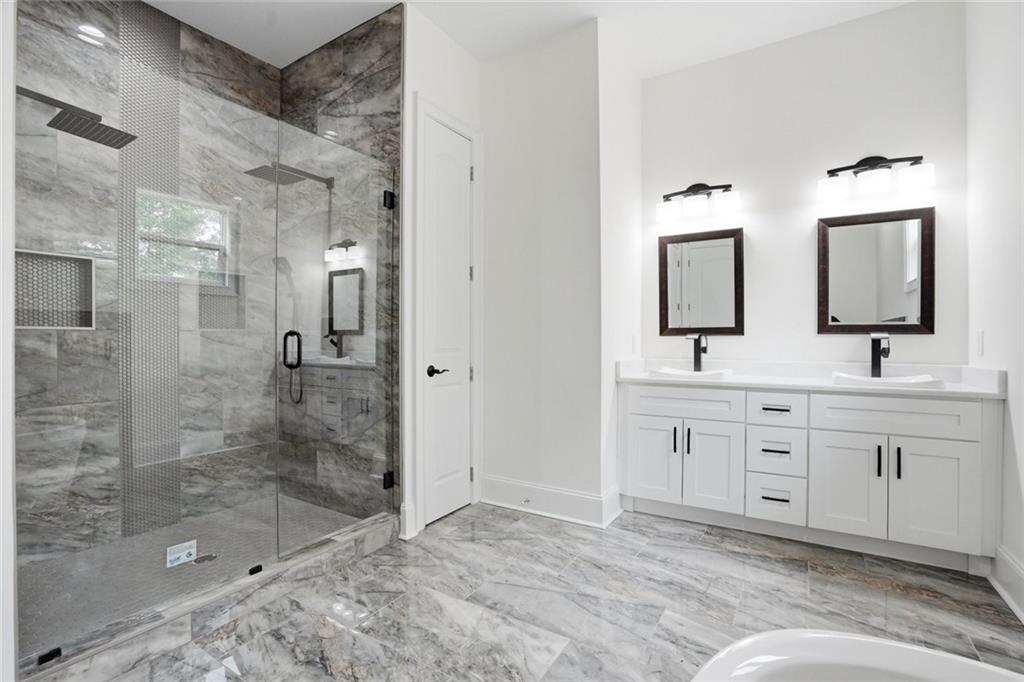 2415 West Rugby Avenue Atlanta, GA 30337 - Photo 17 of 40 a spacious bathroom with double sink and a mirror