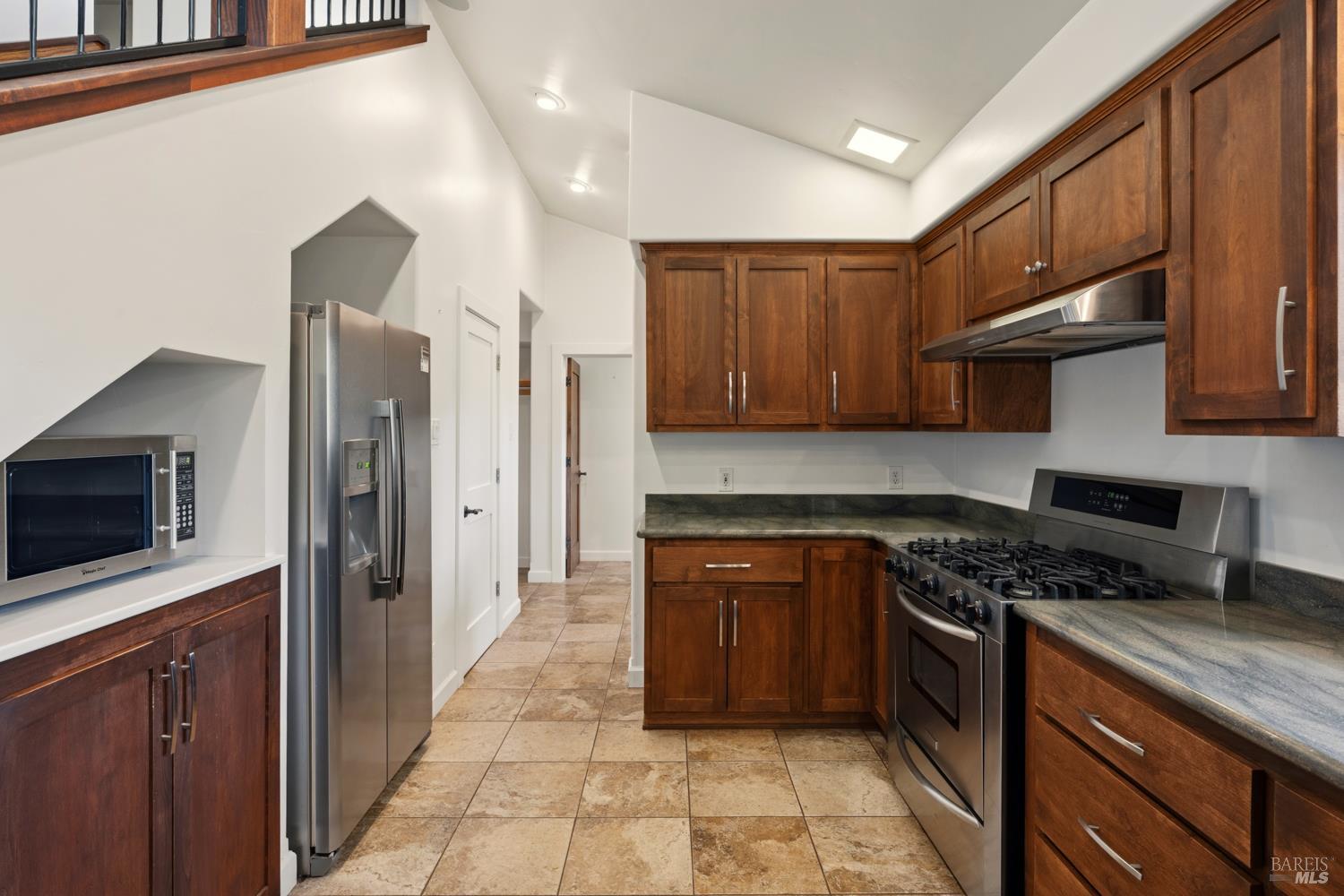 18210 Old Ukiah Pines Road Potter Valley, CA 95469 - Photo 11 of 43 a kitchen with stainless steel appliances granite countertop a stove a sink and a microwave
