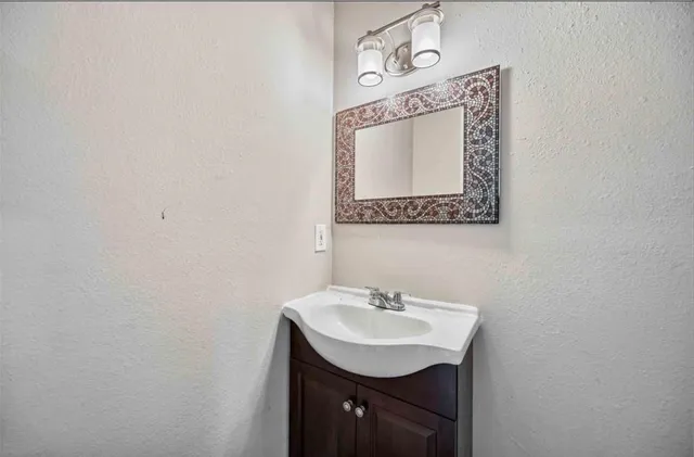 a bathroom with a sink a mirror and a toilet