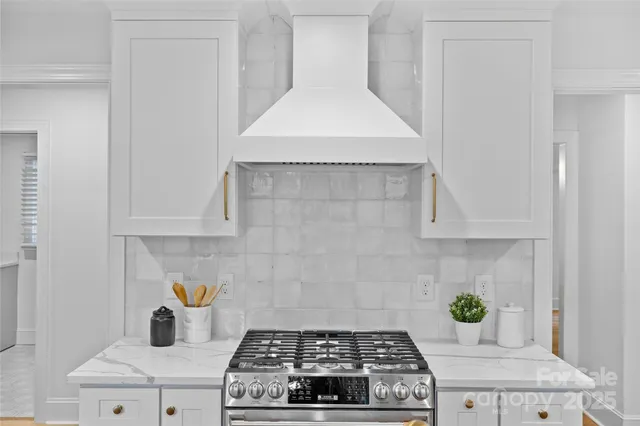 a stove top oven sitting inside of a kitchen