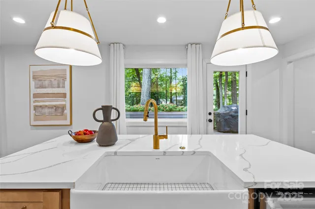 a kitchen with a large window and a chandelier