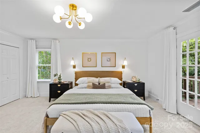 a bedroom with a bed and a chandelier