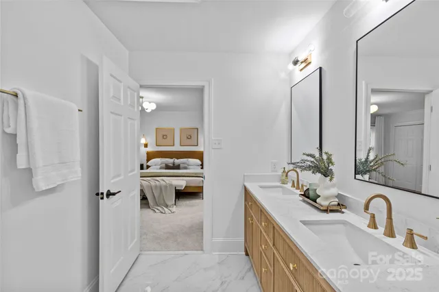 a en suite bathroom with a double vanity sink and a mirror