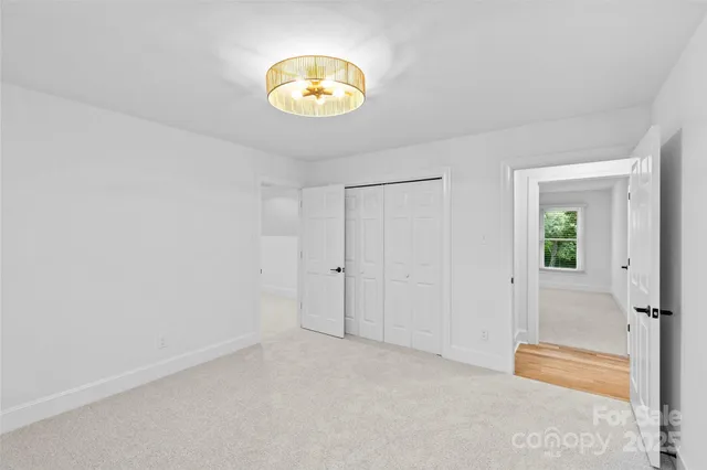 an empty room with windows and glass door