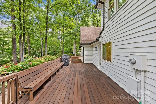 a view of balcony with wooden floor and fence