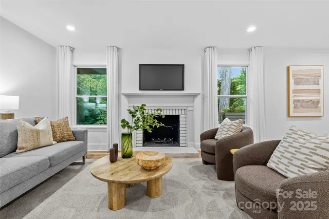 a living room with furniture a window and a fireplace