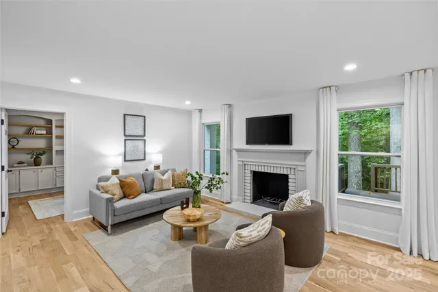 a living room with furniture fireplace and window