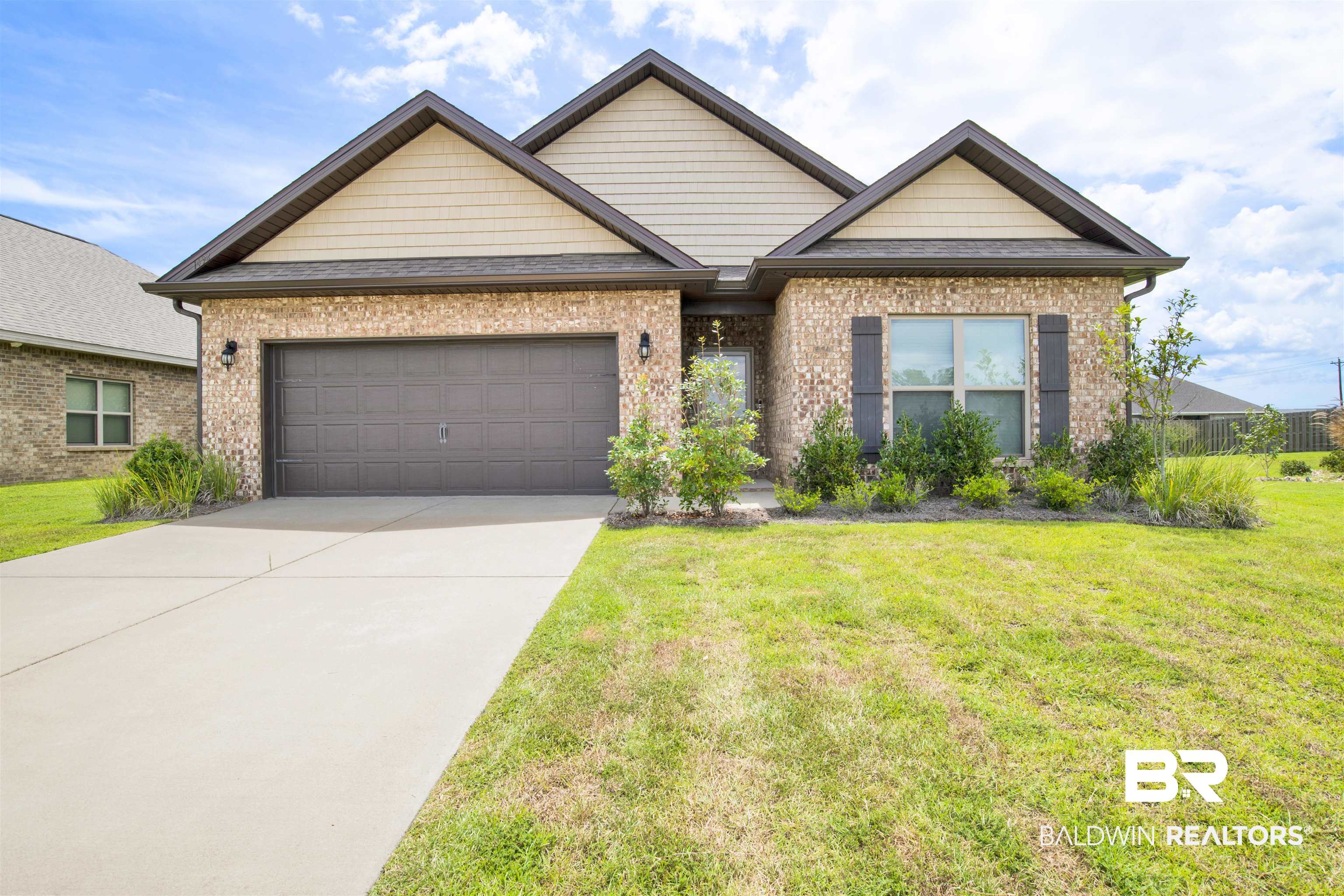View of front of house with a front lawn and a garage