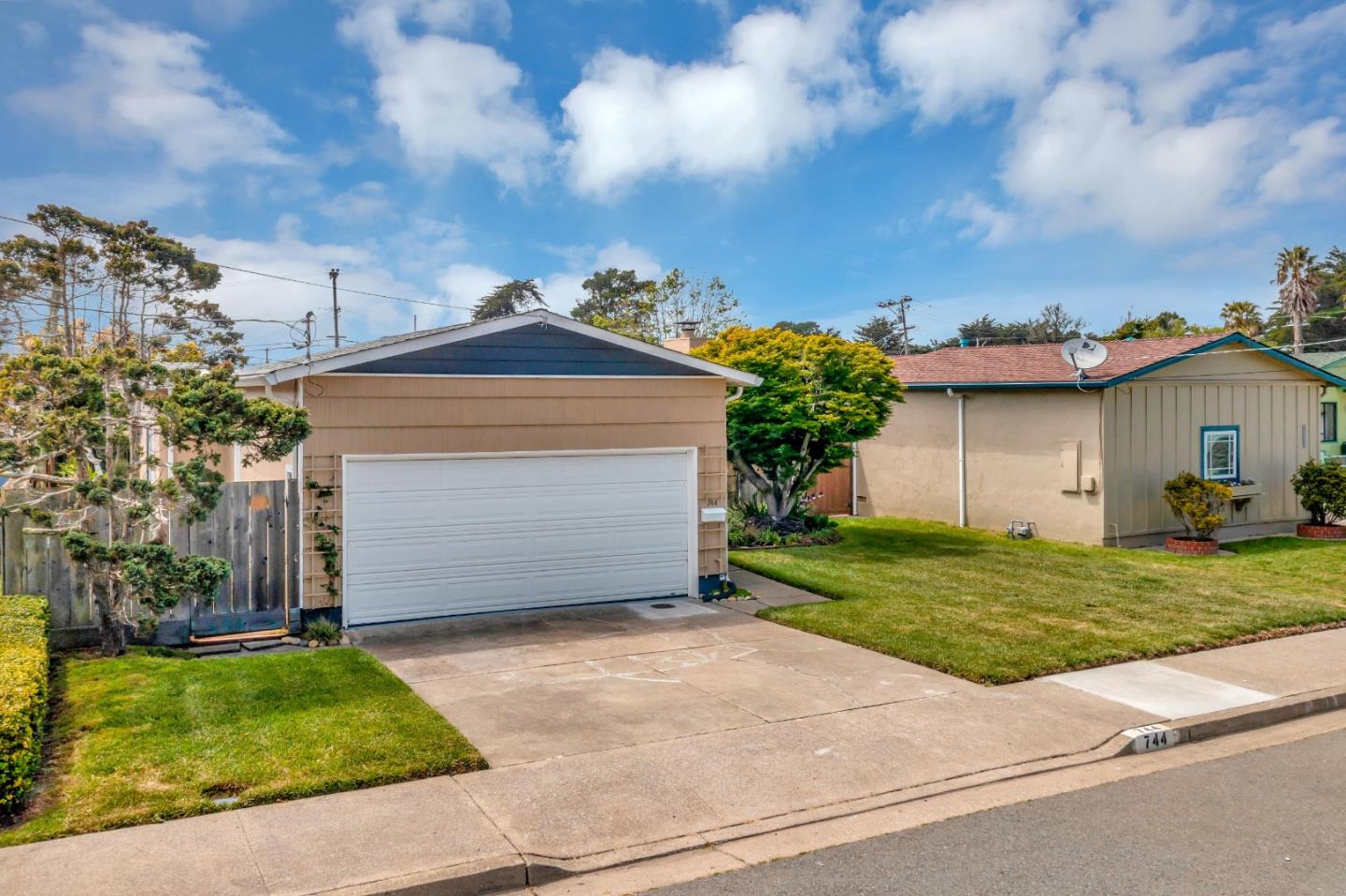 744 Arleen Way Pacifica, CA 94044 - Photo 3 of 9 a front view of a house with a garden and yard