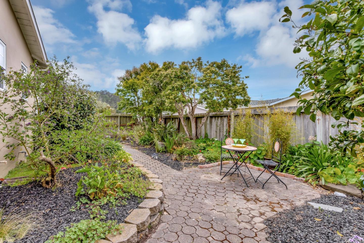 744 Arleen Way Pacifica, CA 94044 - Photo 7 of 9 a view of a backyard with chairs and a flower