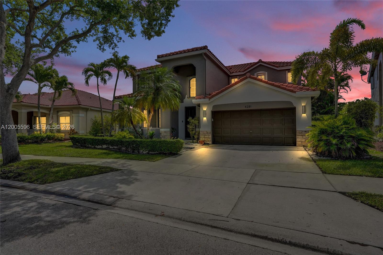 4281 Laurel Ridge Circle Weston, FL 33331 - Photo 7 of 80 a front view of a house with a yard and garage