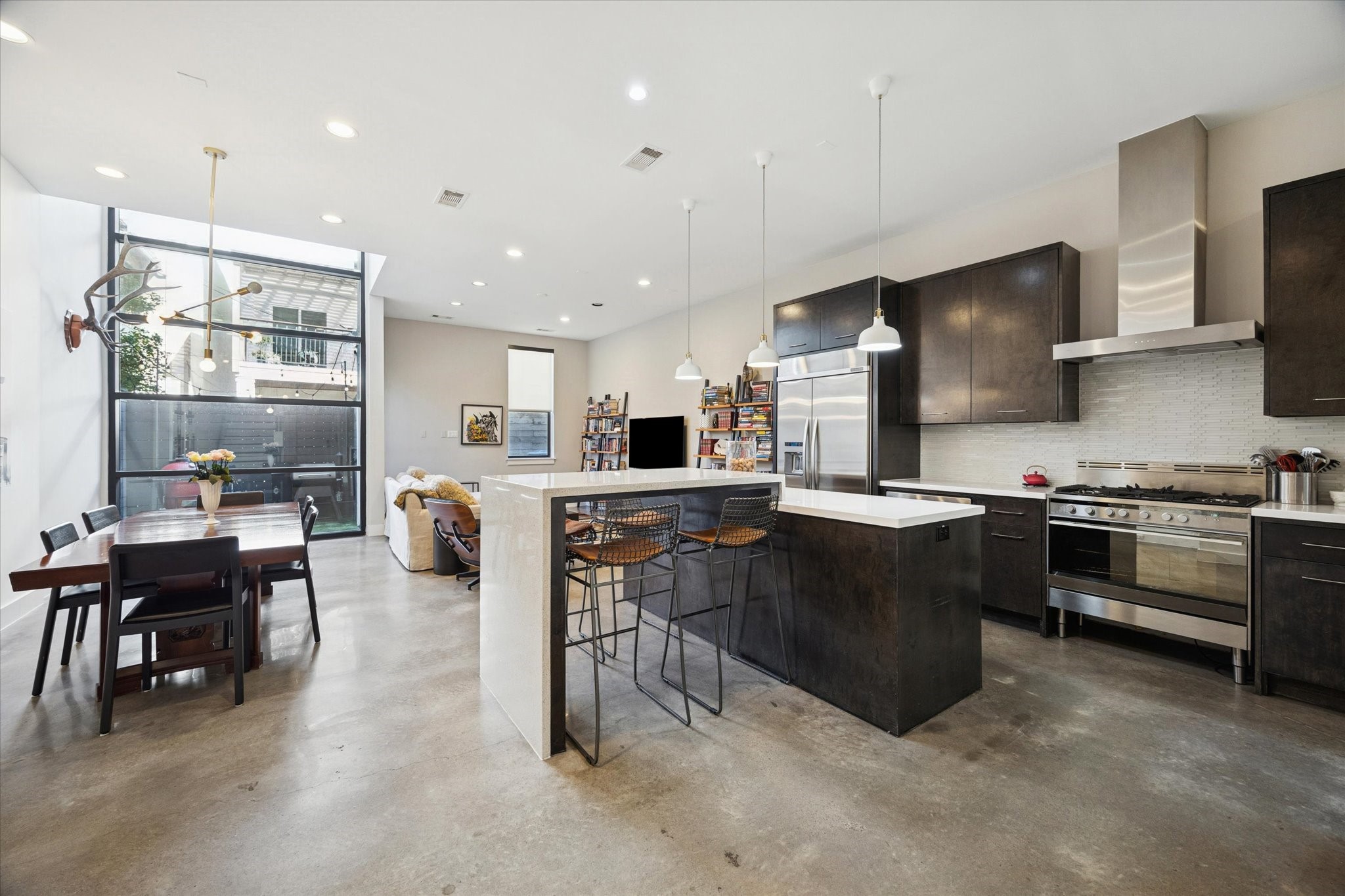 6504 Rodrigo Street, Unit B Houston, TX 77007 - Photo 29 of 29 An open-concept floor plan seamlessly connects the kitchen, dining, and living, while floor-to-ceiling steel windows overlook the private patio.