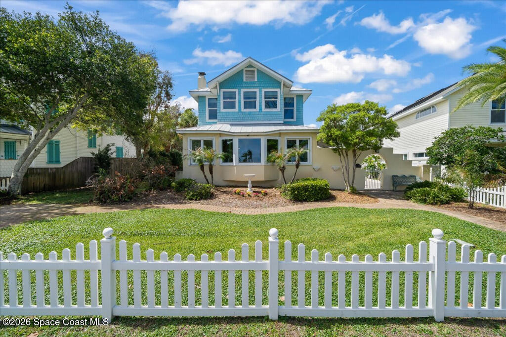 1110 Riverside Drive Titusville, FL 32780 - Photo 1 of 50 a front view of a house with a garden