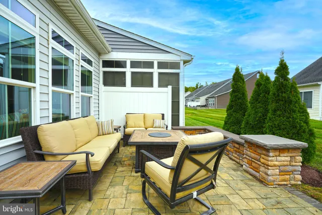a view of a patio with couches table and chairs and potted plants