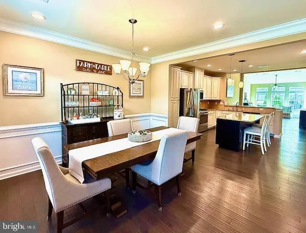 a dining room with furniture window and wooden floor