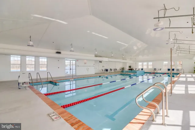 a very nice looking room with a lots of white furniture