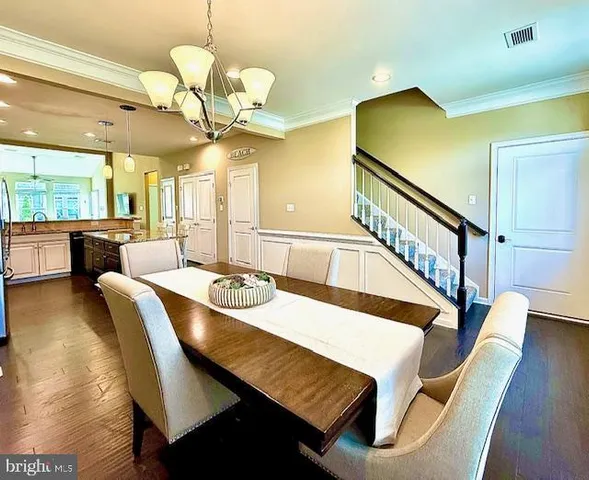 a view of a dining room with furniture and a chandelier