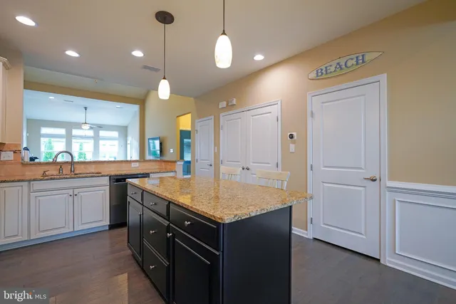 a kitchen that has a lot of cabinets in it and a sink
