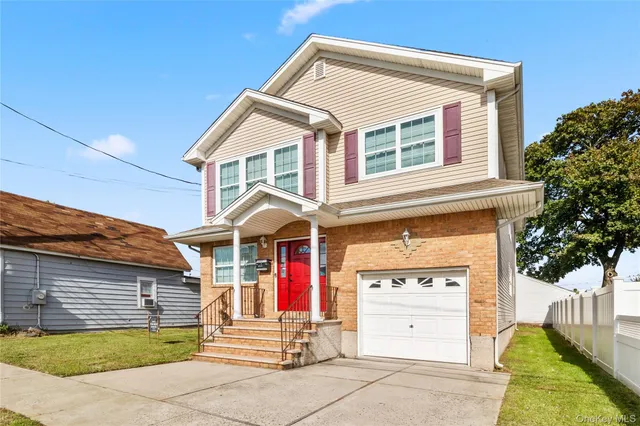 a view of a house with a garage and balcony