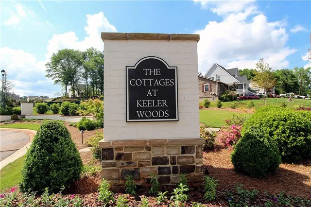 a view of a street with potted plants and a building