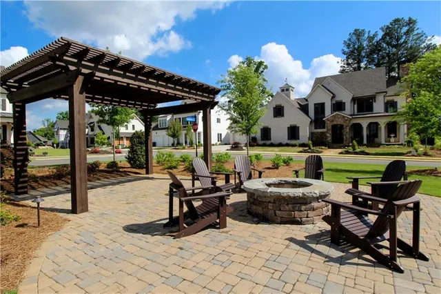 a view of a house with backyard sitting area and swimming pool
