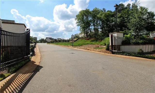 a view of a park with of a house in the background