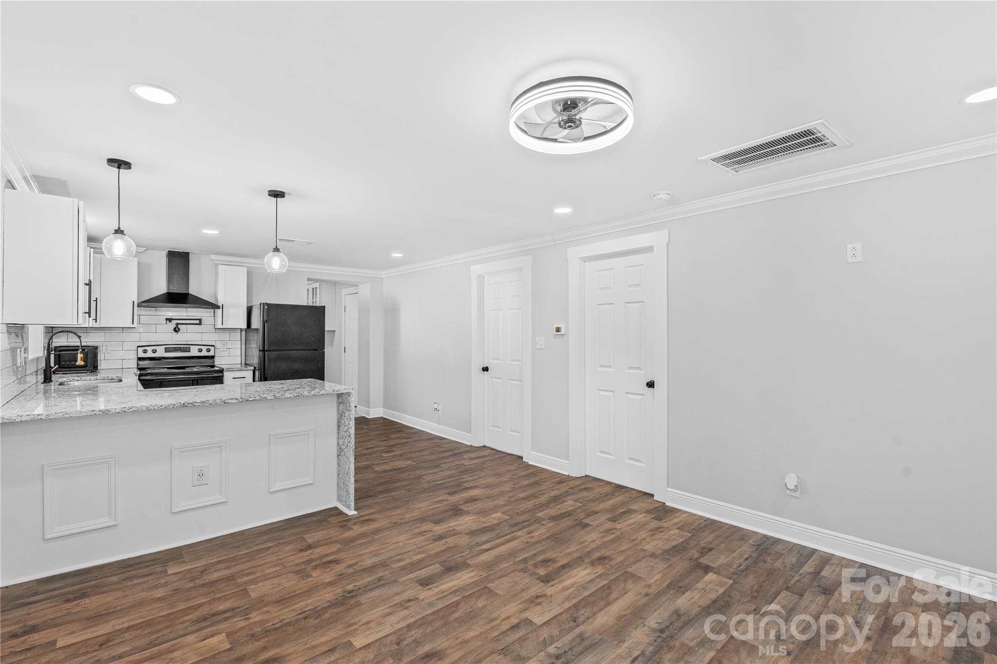 906 Gladstone Street Florence, SC 29501 - Photo 6 of 15 a large white kitchen with kitchen island a sink stainless steel appliances and cabinets