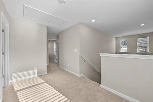 a view of a livingroom with wooden floor and staircase