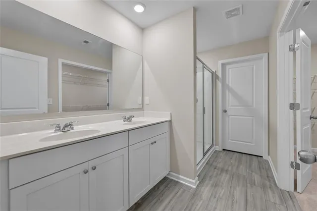 a bathroom with a double vanity sink and mirror