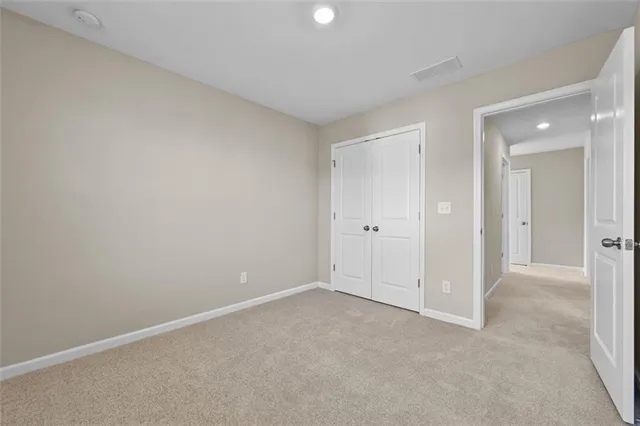 a view of an empty room and closet area