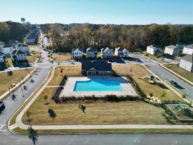a view of a swimming pool with a yard